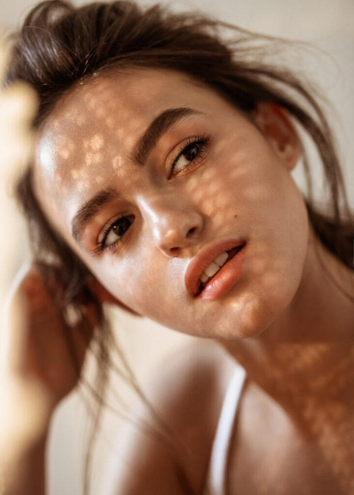 portrait of a model on a sunny day shadows fall on the face and create a beautiful picture
